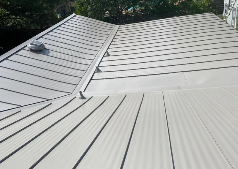 Solar attic fan installed on a metal roof for Roof Ventilation in Narragansett
